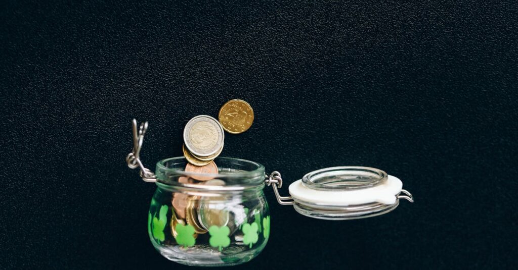 Glass jar with coins falling into it on a black background, symbolizing savings.